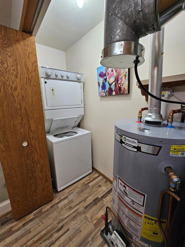 21965 Shady Walk Unit 201, Deerwood, MN 56444 - clothes washing area with water heater, stacked washer and clothes dryer, a textured ceiling, laundry area, and wood finished floors