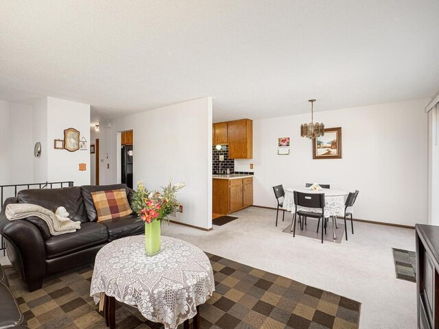 15722 Griffon Ct, Apple Valley, MN 55124 - living area with dark colored carpet, a chandelier, and baseboards