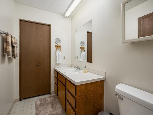 15722 Griffon Ct, Apple Valley, MN 55124 - bathroom featuring tile patterned floors, toilet, and vanity