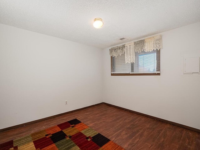 15722 Griffon Ct, Apple Valley, MN 55124 - spare room featuring wood finished floors, baseboards, and a textured ceiling