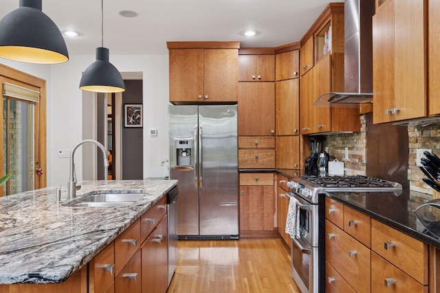 1295 Fairmount Ave, Saint Paul, MN 55105 - kitchen with stainless steel appliances, wall chimney exhaust hood, light wood-style floors, brown cabinetry, and recessed lighting
