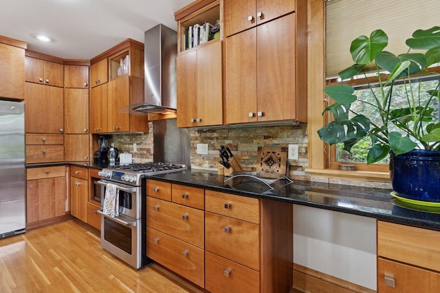 1295 Fairmount Ave, Saint Paul, MN 55105 - kitchen with wall chimney range hood, appliances with stainless steel finishes, light wood finished floors, decorative backsplash, and recessed lighting