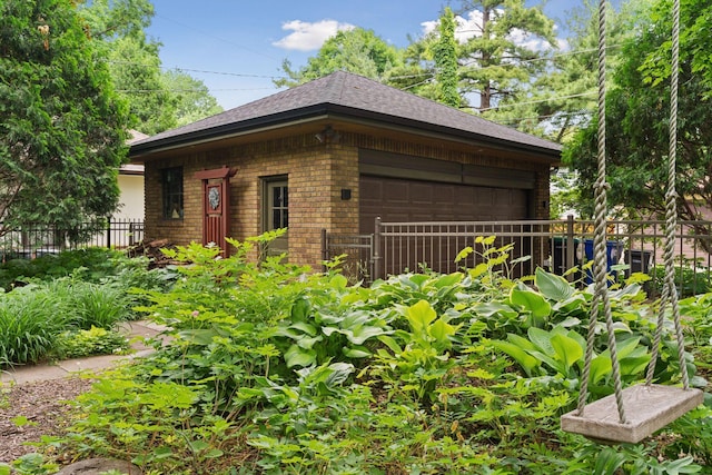 1295 Fairmount Ave, Saint Paul, MN 55105 - view of property exterior with brick siding, a garage, and a shingled roof
