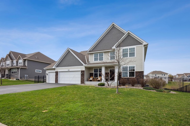 view of front of house with fence, driveway, a front yard, and covered porch