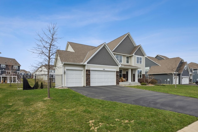craftsman inspired home with fence, driveway, a front yard, and a garage