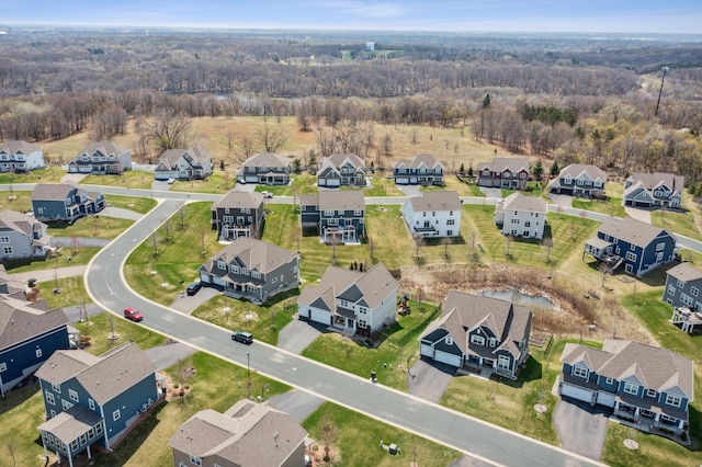 bird's eye view with a wooded view and a residential view