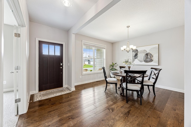 dining area featuring baseboards, dark wood-style floors, and a chandelier