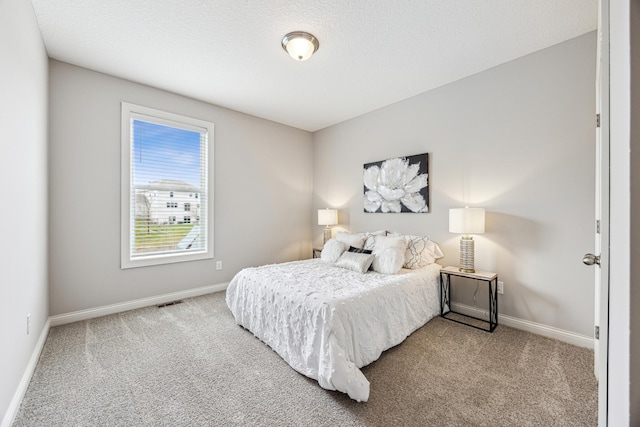 carpeted bedroom with baseboards and visible vents
