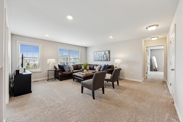 living area with carpet floors, recessed lighting, and baseboards