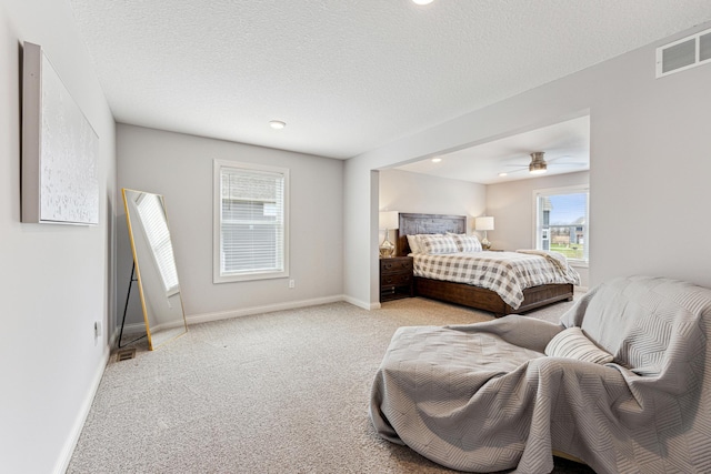 carpeted bedroom with a ceiling fan, baseboards, visible vents, and recessed lighting