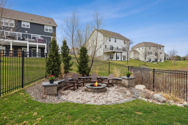 view of yard featuring a fenced backyard, a patio, an outdoor fire pit, and a residential view