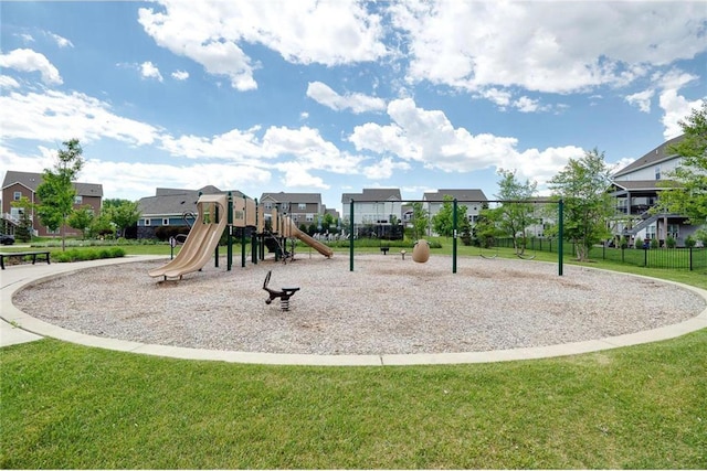 community playground with a yard, fence, and a residential view