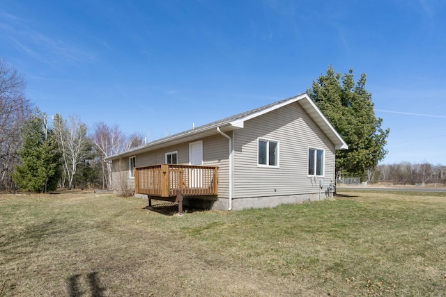 rear view of property featuring a wooden deck and a yard