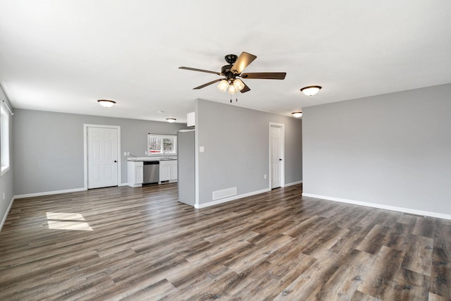 unfurnished living room with baseboards, a ceiling fan, visible vents, and dark wood-type flooring