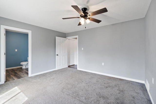 unfurnished bedroom featuring connected bathroom, carpet floors, and baseboards
