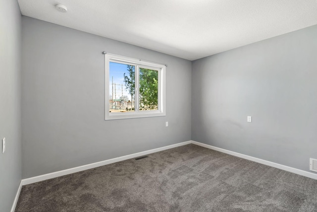 unfurnished room with baseboards, visible vents, and carpet