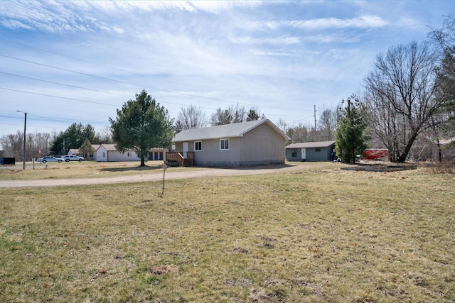 exterior space with a front yard and concrete driveway