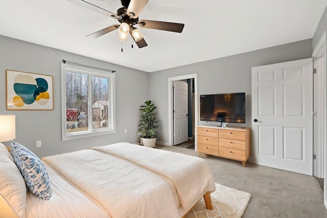 bedroom with light carpet and ceiling fan