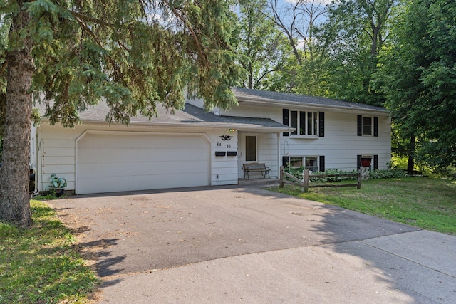 84 Logan Ave W, West Saint Paul, MN 55118 - tri-level home with concrete driveway, an attached garage, and a front yard
