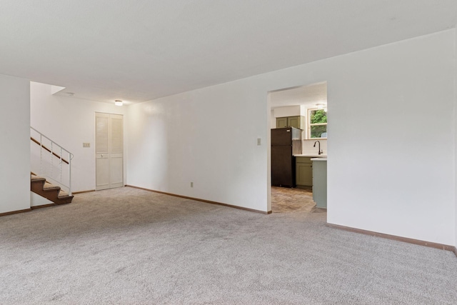 84 Logan Ave W, West Saint Paul, MN 55118 - unfurnished living room featuring light carpet and stairs