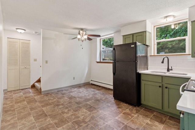 84 Logan Ave W, West Saint Paul, MN 55118 - kitchen featuring green cabinets, freestanding refrigerator, a baseboard heating unit, light countertops, and ceiling fan