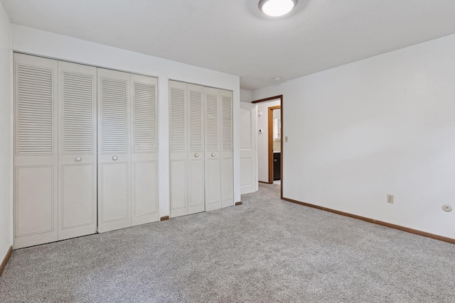 84 Logan Ave W, West Saint Paul, MN 55118 - unfurnished bedroom featuring two closets and carpet