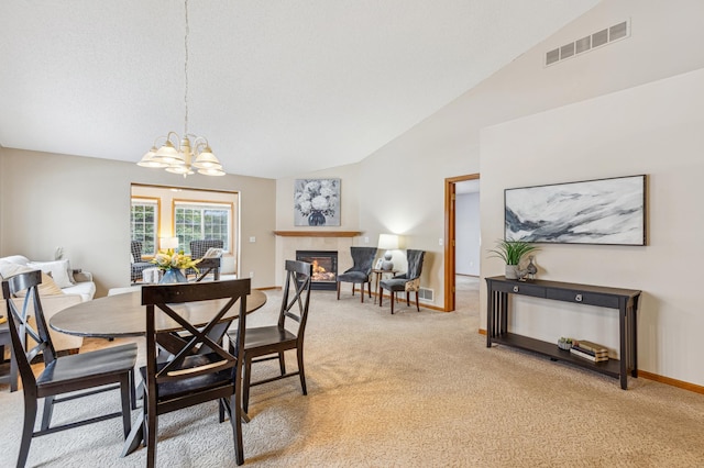 3621 Lansing Ave NE, Saint Michael, MN 55376 - dining room with light colored carpet, a tile fireplace, a chandelier, and high vaulted ceiling