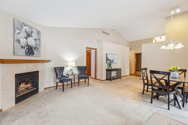 3621 Lansing Ave NE, Saint Michael, MN 55376 - dining space featuring carpet, a fireplace, vaulted ceiling, and a chandelier