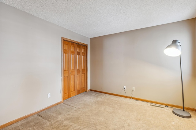 3621 Lansing Ave NE, Saint Michael, MN 55376 - unfurnished bedroom with light colored carpet, a textured ceiling, and a closet