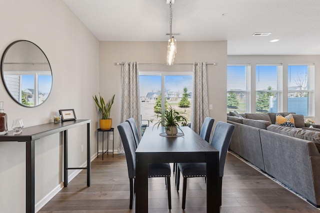 dining room with dark wood-type flooring and visible vents
