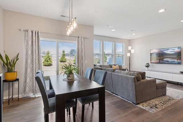 dining space featuring wood finished floors, visible vents, and recessed lighting