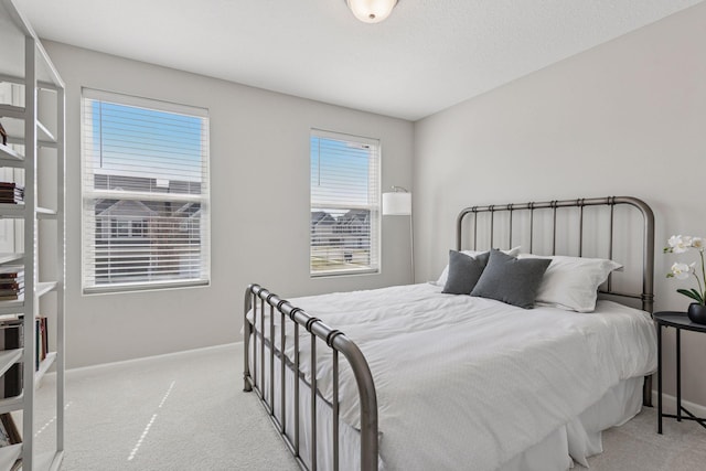 carpeted bedroom with baseboards