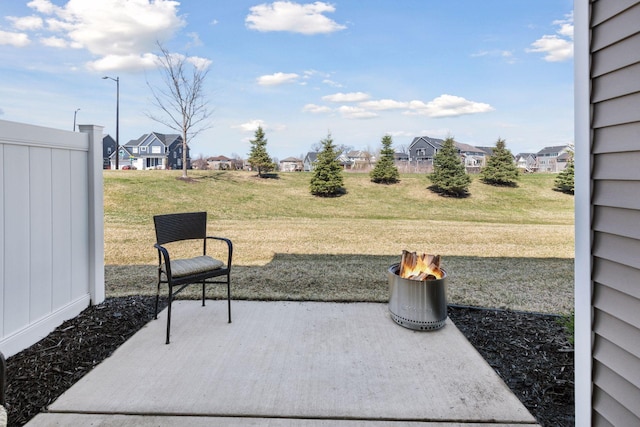 view of patio with a fire pit and a residential view