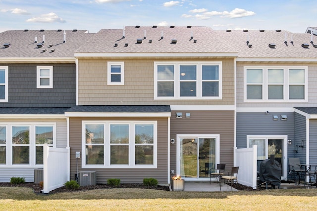 rear view of house featuring a yard, a patio area, and central AC