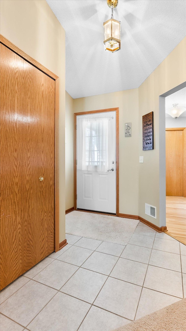 112 Sandpiper Cir, Hastings, MN 55033 - foyer entrance with tile patterned floors, baseboards, and a textured ceiling
