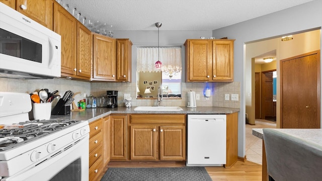 112 Sandpiper Cir, Hastings, MN 55033 - kitchen featuring white appliances, a sink, backsplash, pendant lighting, and a textured ceiling