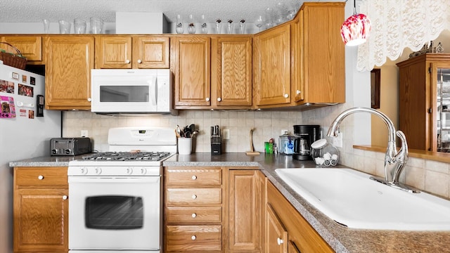 112 Sandpiper Cir, Hastings, MN 55033 - kitchen with white appliances, a sink, tasteful backsplash, brown cabinets, and a textured ceiling