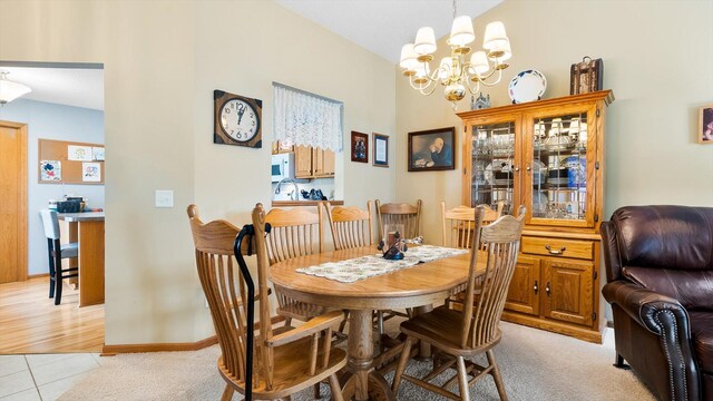 112 Sandpiper Cir, Hastings, MN 55033 - dining space featuring a chandelier, light tile patterned floors, and baseboards