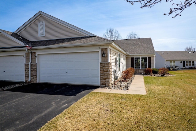 112 Sandpiper Cir, Hastings, MN 55033 - view of front of house with stone siding, driveway, a front yard, a garage, and roof with shingles