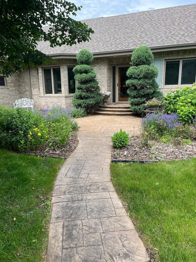 3931 Crestview Dr, Chanhassen, MN 55331 - view of exterior entry with brick siding and a shingled roof
