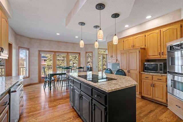 3931 Crestview Dr, Chanhassen, MN 55331 - kitchen with a textured ceiling, stainless steel appliances, a center island, light wood-style floors, and dark cabinetry