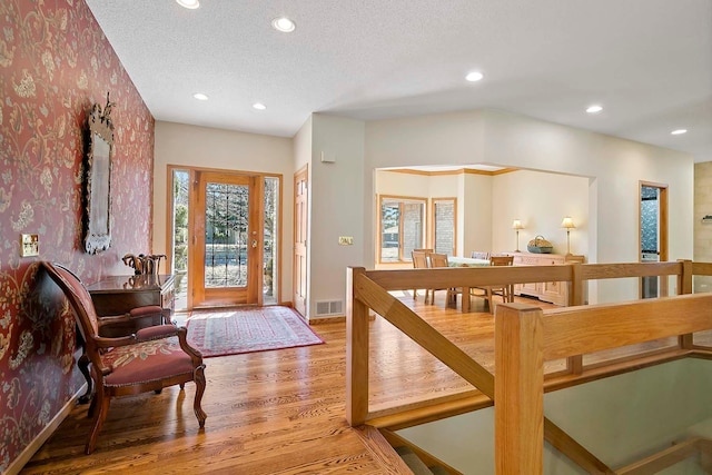 3931 Crestview Dr, Chanhassen, MN 55331 - entrance foyer featuring wallpapered walls, light wood-style flooring, and recessed lighting