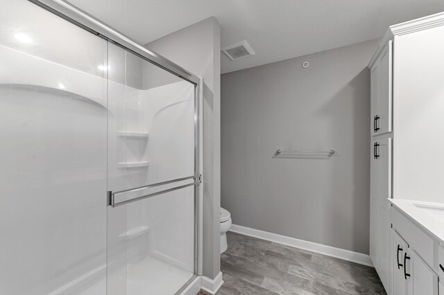 22962 Hazel Ln, Rogers, MN 55374 - full bath featuring a shower stall, toilet, vanity, and marble finish flooring