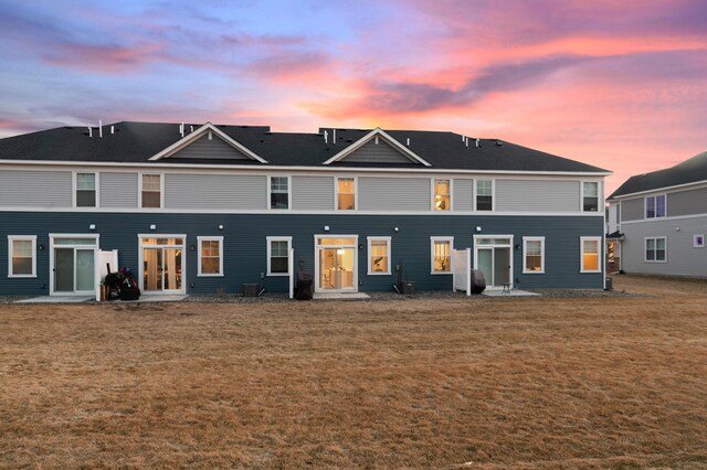 22962 Hazel Ln, Rogers, MN 55374 - back of house at dusk with a lawn