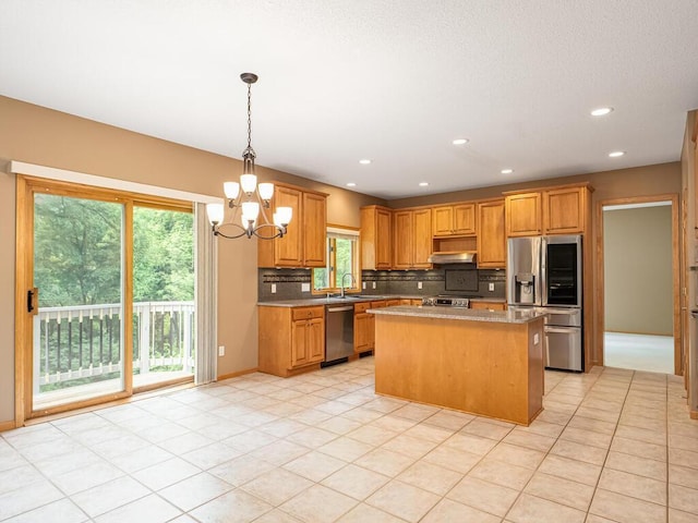 1844 Red Fox Rd, Eagan, MN 55122 - kitchen with stainless steel appliances, a chandelier, tasteful backsplash, a kitchen island, and under cabinet range hood