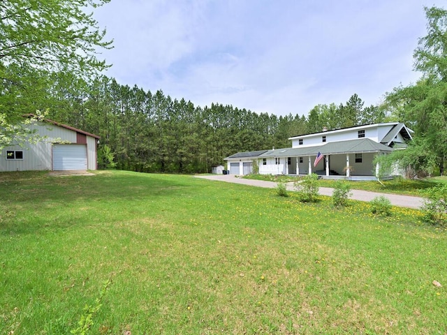 21327 Keyview Rd, Grand Rapids, MN 55744 - view of grassy yard with a garage and a porch