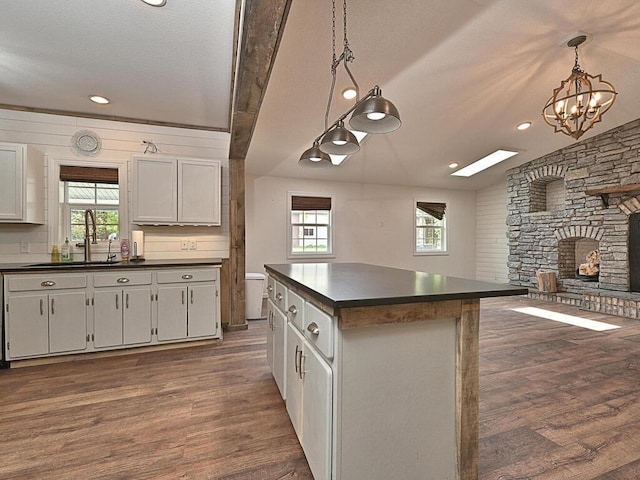 21327 Keyview Rd, Grand Rapids, MN 55744 - kitchen with a sink, dark countertops, dark wood-style flooring, a chandelier, and recessed lighting