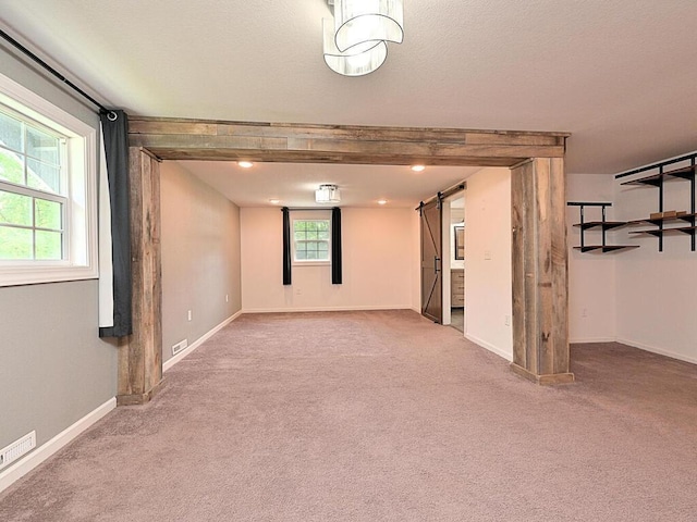 21327 Keyview Rd, Grand Rapids, MN 55744 - carpeted empty room featuring a barn door and baseboards