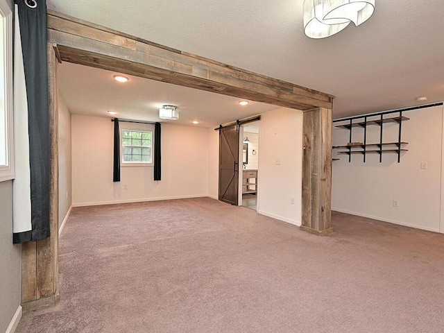 21327 Keyview Rd, Grand Rapids, MN 55744 - basement with a barn door, carpet floors, baseboards, and recessed lighting