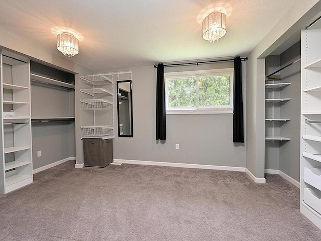21327 Keyview Rd, Grand Rapids, MN 55744 - unfurnished bedroom with carpet floors, baseboards, and a chandelier